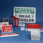 Various safety and promotional signs displayed together.