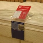 Mattress with sale tag on display in store.
