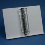 White tabletop binder display with metal rings