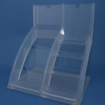 Clear plastic brochure holder on blue background.